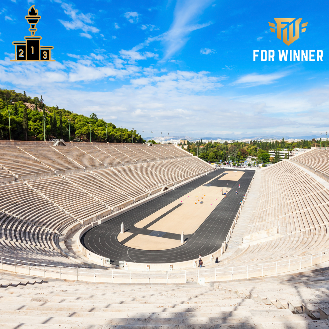 Stadion olimpijski który widnieje na medalach olimpijskich. W rogach logo firmy For Winner oraz podium ze zniczem olimpijskim.
